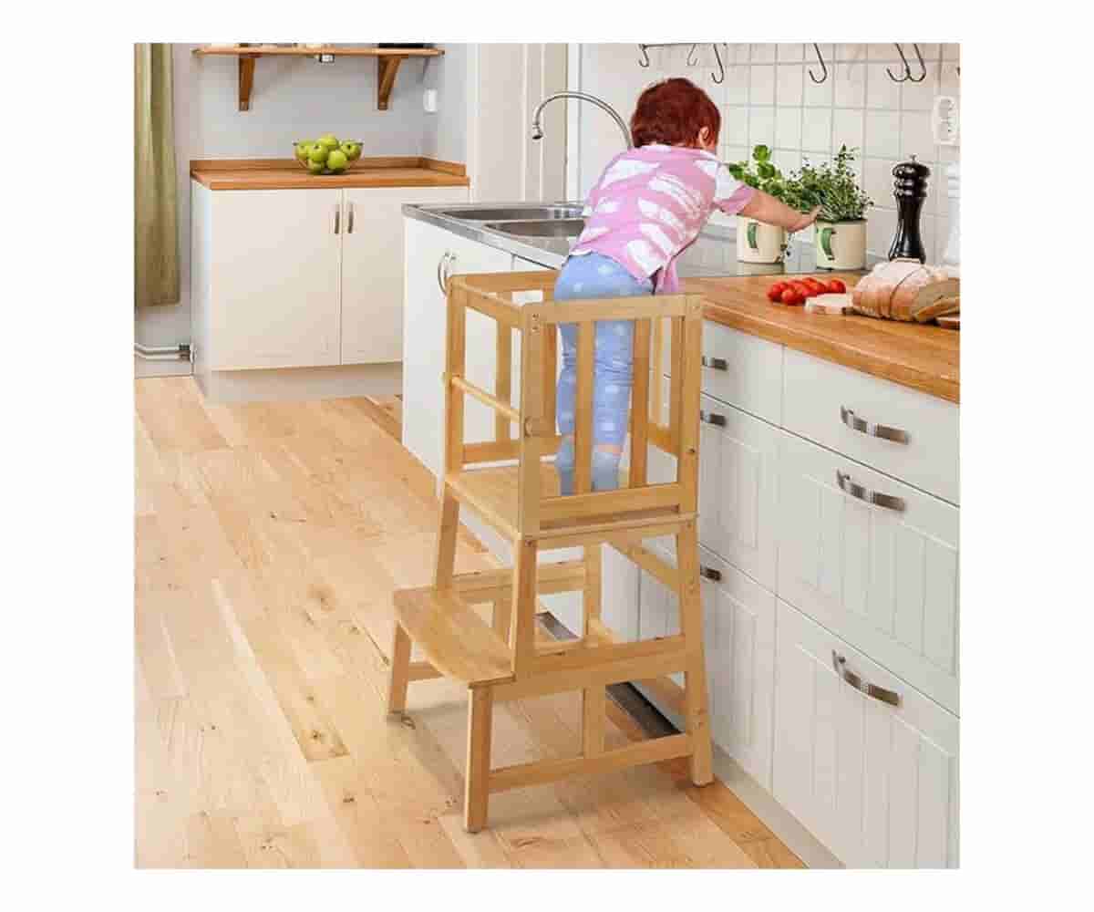 The COSYLAND Kids Kitchen Step Stool, crafted from natural bamboo with a patented anti-tip design, provides a safe and stable platform for toddlers to engage in kitchen activities.